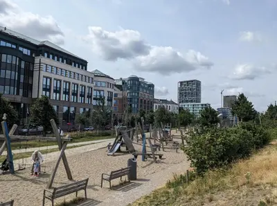 a park with benches and buildings in a city at luxe en authenticiteit in Antwerp