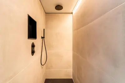 a bathroom with a shower with a walk in shower at luxe en authenticiteit in Antwerp