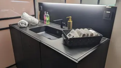 a bathroom counter with a sink and a basket of towels at luxe en authenticiteit in Antwerp