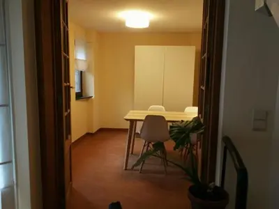 a room with a table and a chair in a room at Triplex près de la Grand-Place in Brussels