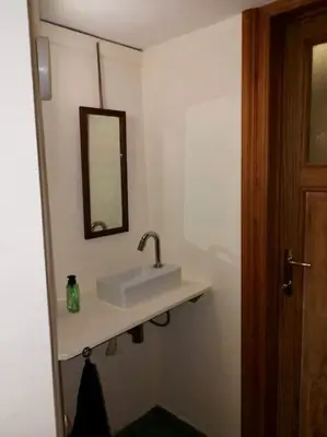 a bathroom with a sink and a mirror on the wall at Triplex près de la Grand-Place in Brussels
