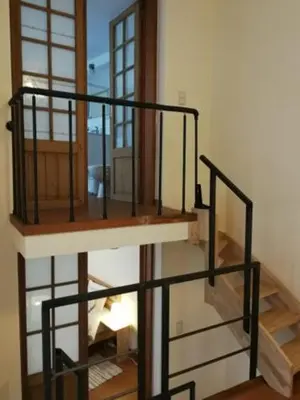 a spiral staircase in a room with a window at Triplex près de la Grand-Place in Brussels