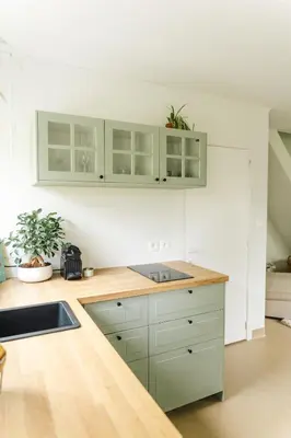 a kitchen with green cabinets and a counter top at Bijgebouw hoeve in landelijke omgeving in Putte
