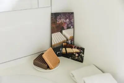 a chocolate bar sitting on a counter next to a mirror at Bijgebouw hoeve in landelijke omgeving in Putte